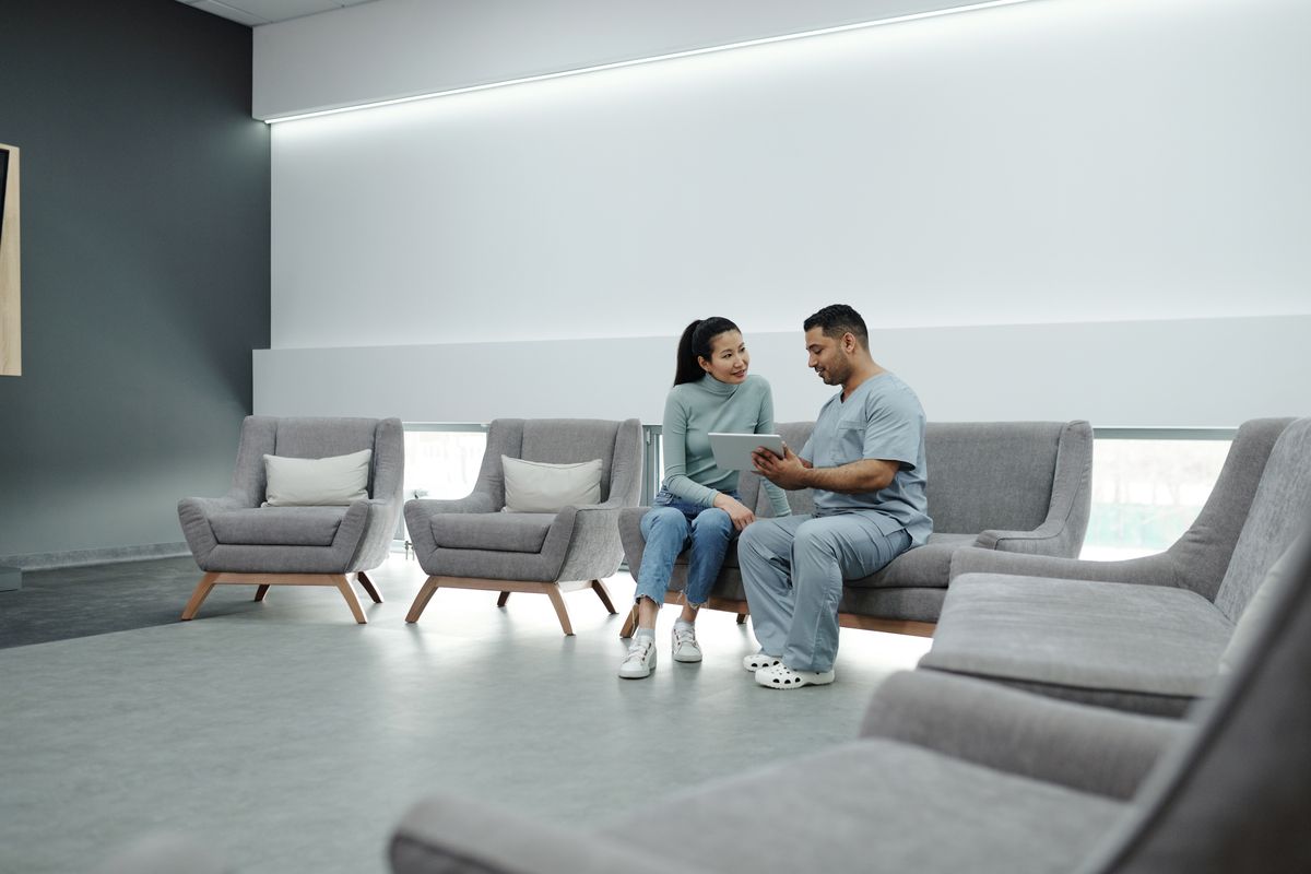 A doctor consulting a female patient in a modern clinic
