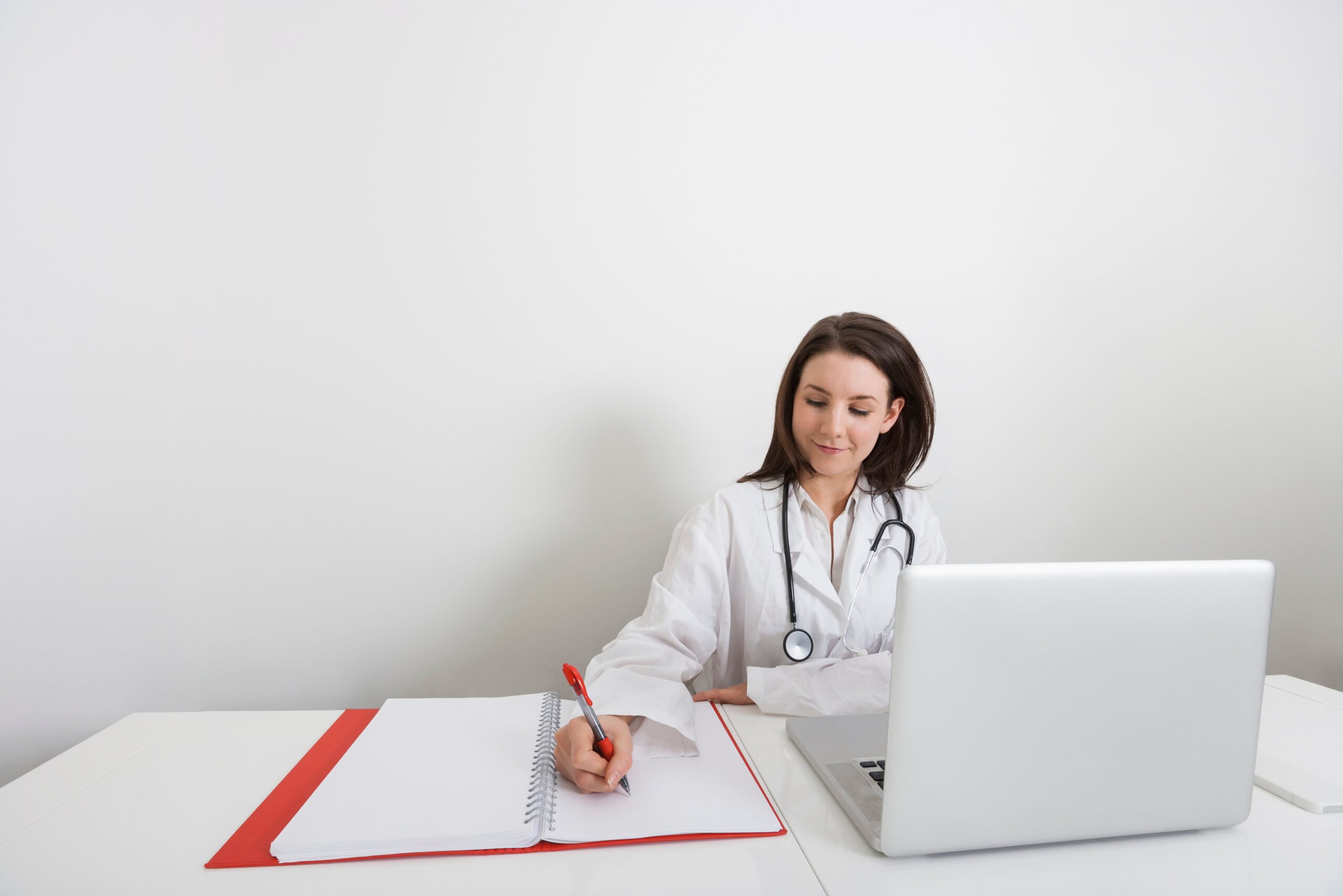 A provider at Encompass Wellness and Aesthetics reviewing patient notes